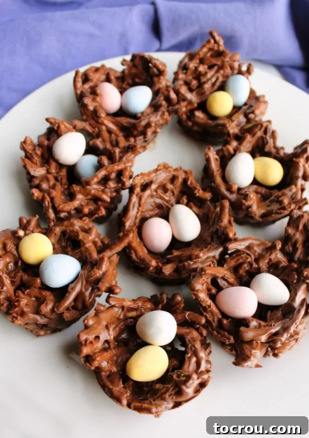Serving plate filled with chocolate bird nest treats with cadbury mini eggs inside.