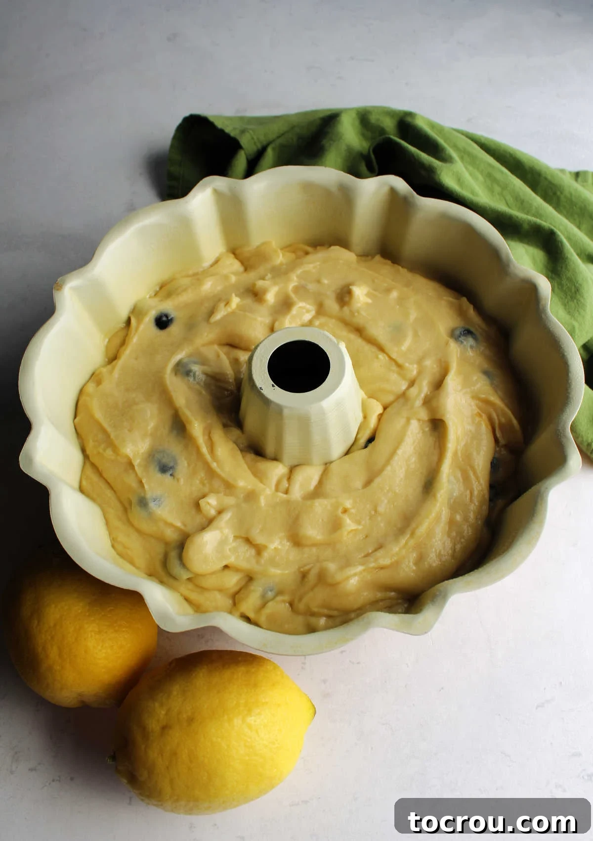 Lemon Blueberry Bliss Bundt 6 Smooth lemon blueberry cake batter neatly poured into a Bundt pan, ready for baking.
