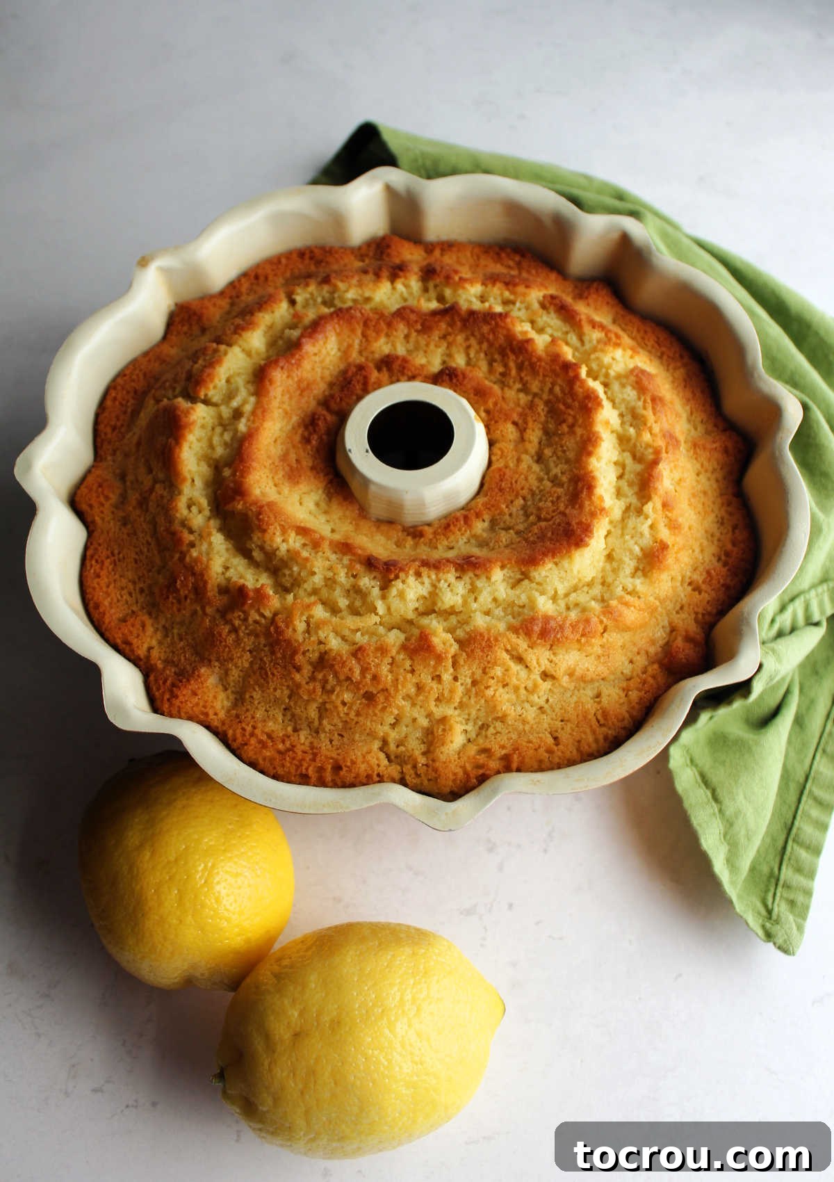 Lemon Blueberry Bliss Bundt 7 A perfectly baked lemon blueberry cake still in its Bundt pan, fresh out of the oven.