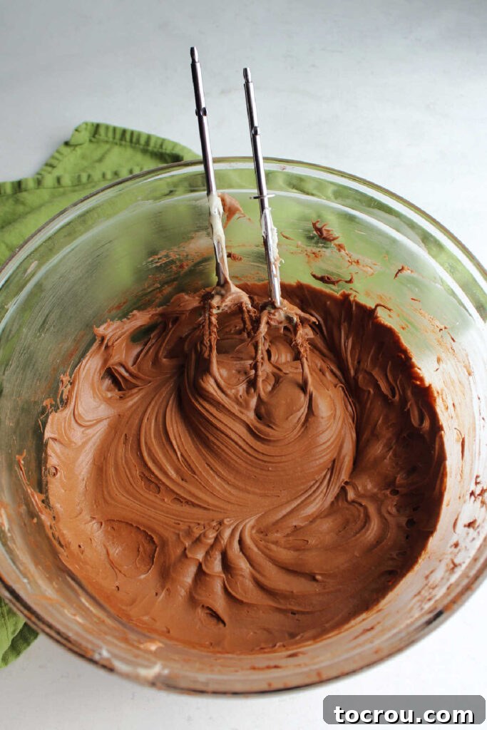 Decadent Chocolate Cream Cheese Frosting 4 Mixing bowl filled with smooth chocolate cream cheese frosting.