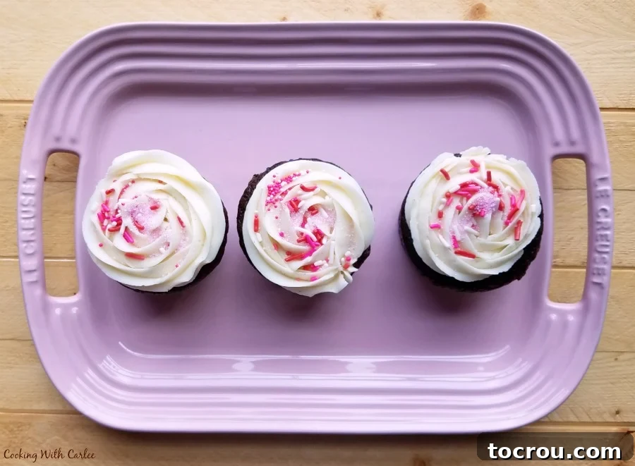 Banana makes these cupcakes moist and delicious. They are the perfect combo of chocolate, banana and cake! platter of frosted cupcakes with sprinkles on top.