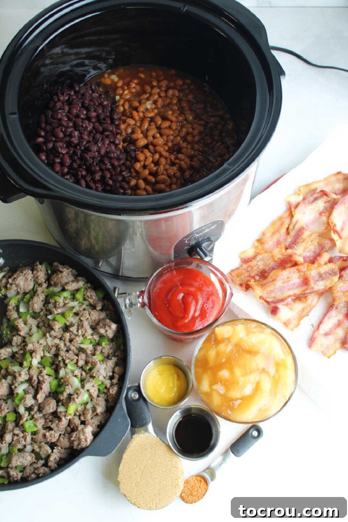 Ultimate Slow-Cooked Baked Beans 3 Ingredients for loaded baked beans, including canned beans, apple pie filling, crispy bacon, and cooked sausage, neatly arranged and ready for preparation.