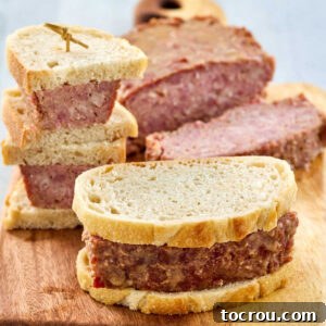 Ham loaf cut into thick slices with a couple of slices served as a big sandwich on hearty bread.