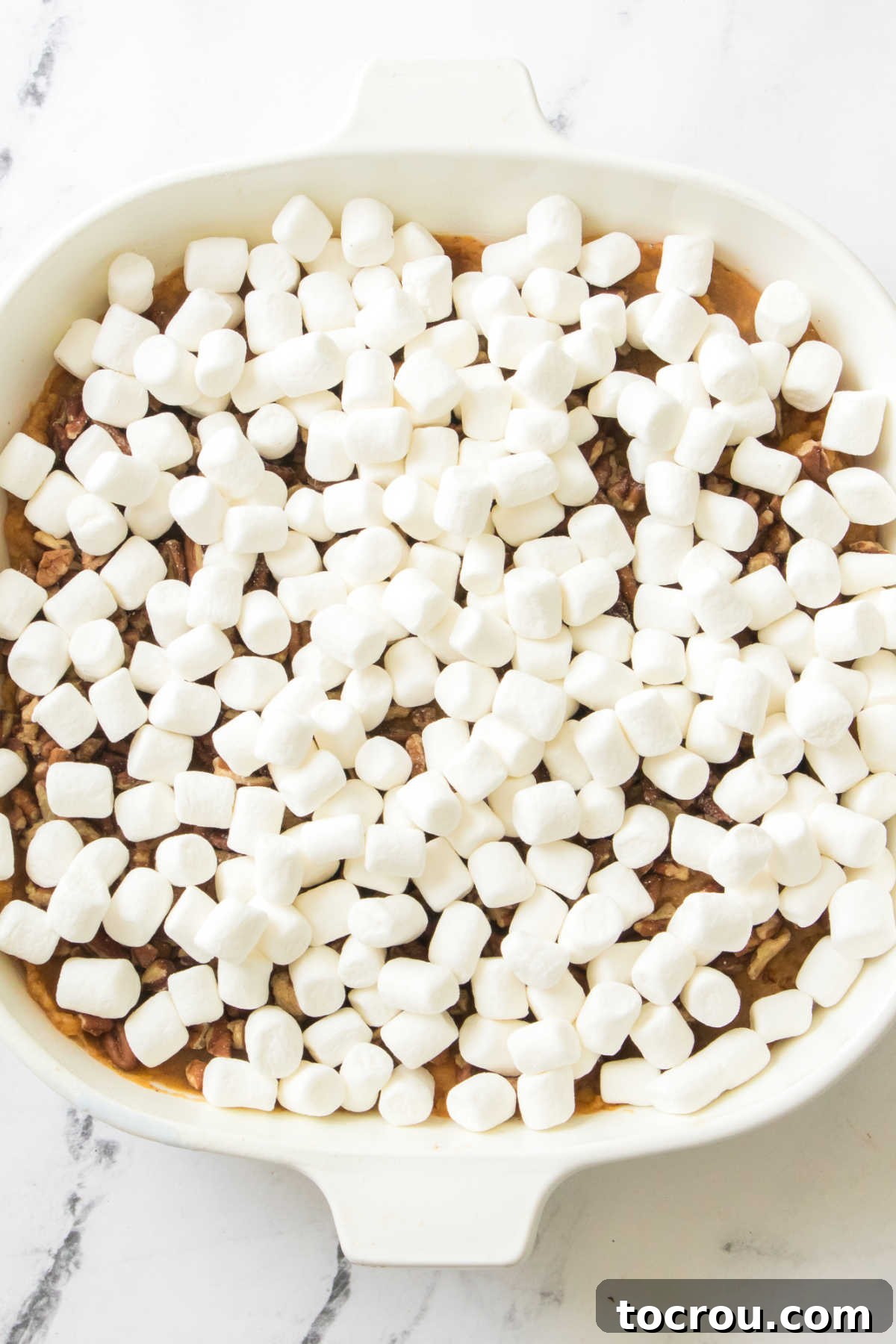 Marshmallows sprinkled over sweet potato layer. 