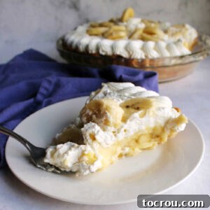slice of banana cream pie ready to eat.