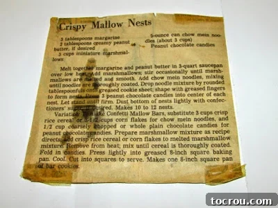 The Original Crispy Mallow Nests Recipe A close-up of a yellowed, vintage newspaper clipping featuring the cherished 'Crispy Mallow Nests' recipe, a precious family heirloom that inspired decades of spring traditions.