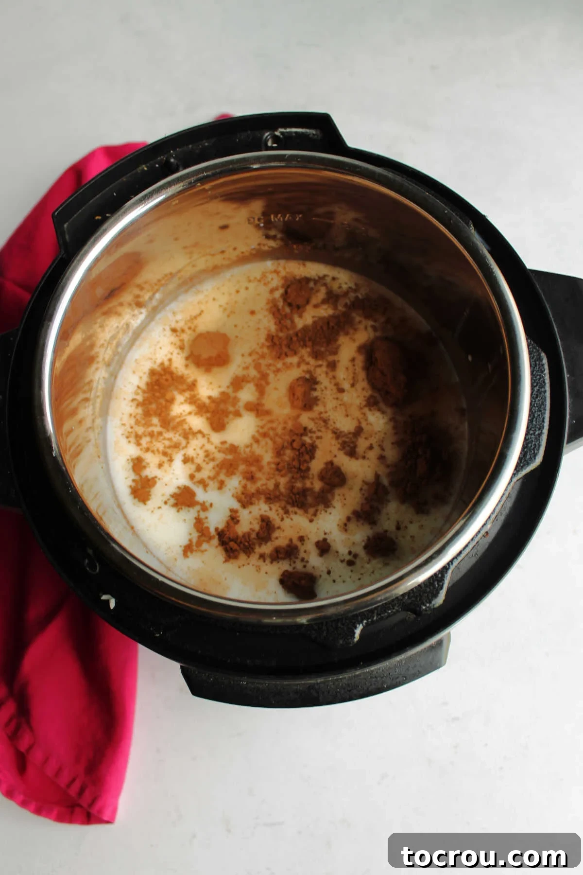 Decadent Instant Pot Chocolate Rice Pudding 5 Milk, rice, water and cocoa powder in instant pot ready to cook.