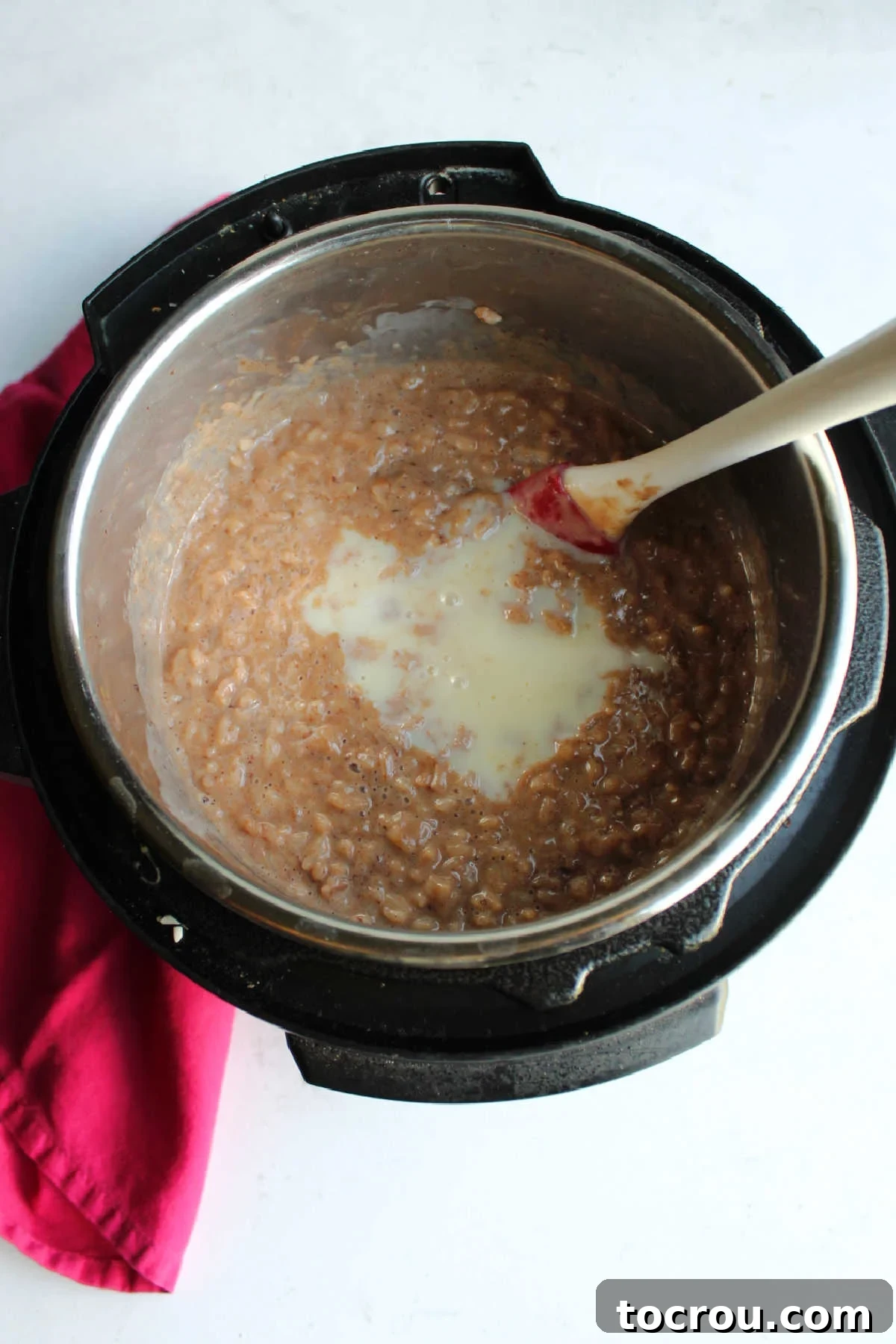 Decadent Instant Pot Chocolate Rice Pudding 6 Cooked rice, milk and cocoa mixture in instant pot with condensed milk ready to be stirred in.