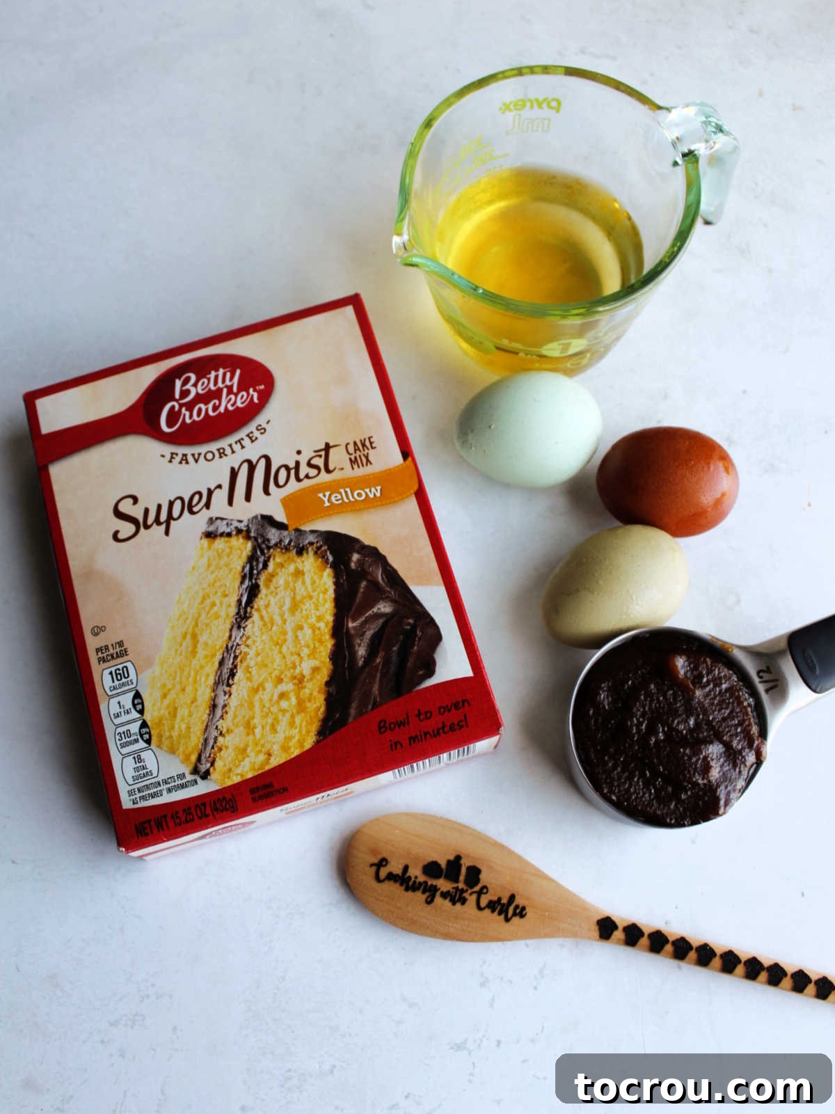 Ingredients (oil, eggs, apple butter and cake mix) ready to be made into mini cupcakes.