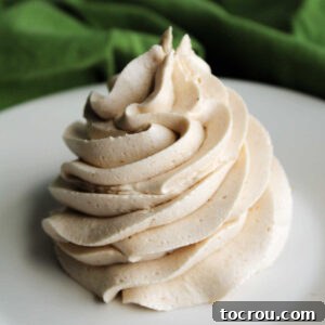 Large piped swirl of creamy apple butter buttercream frosting.
