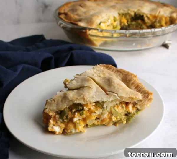 Golden brown pot pie, filled with diced ham, vibrant broccoli florets, and melted cheese, ready to be served.