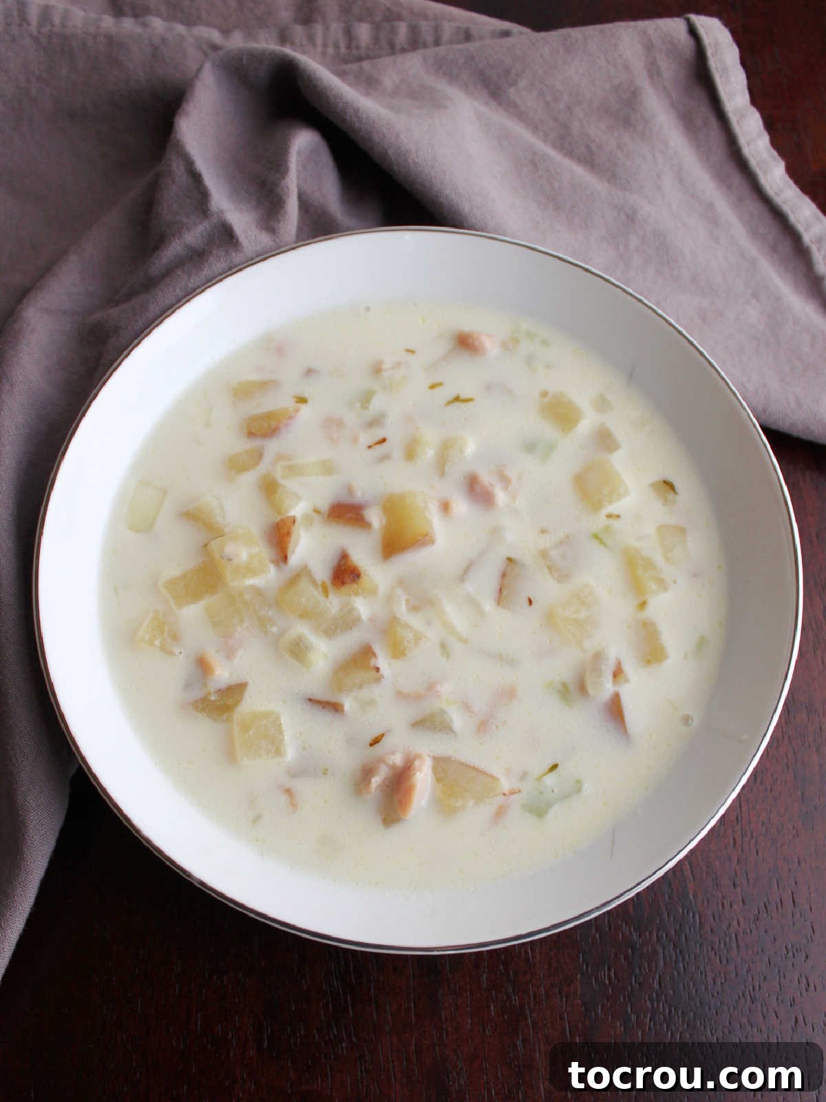 Bowl of creamy New England Clam chowder, ready to be eaten.