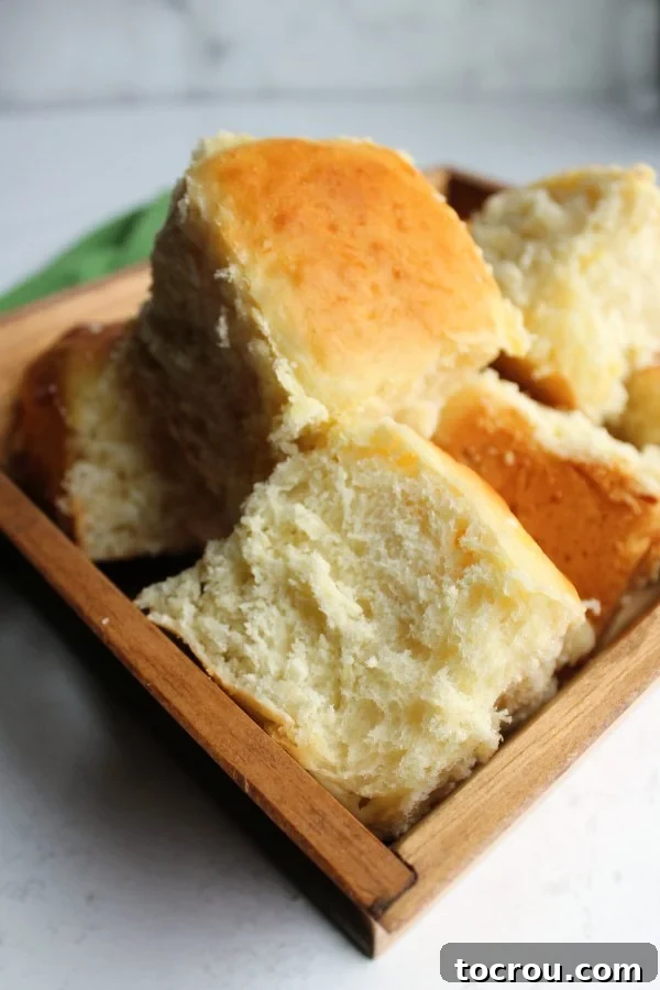 Tender, golden pineapple dinner rolls arranged beautifully.