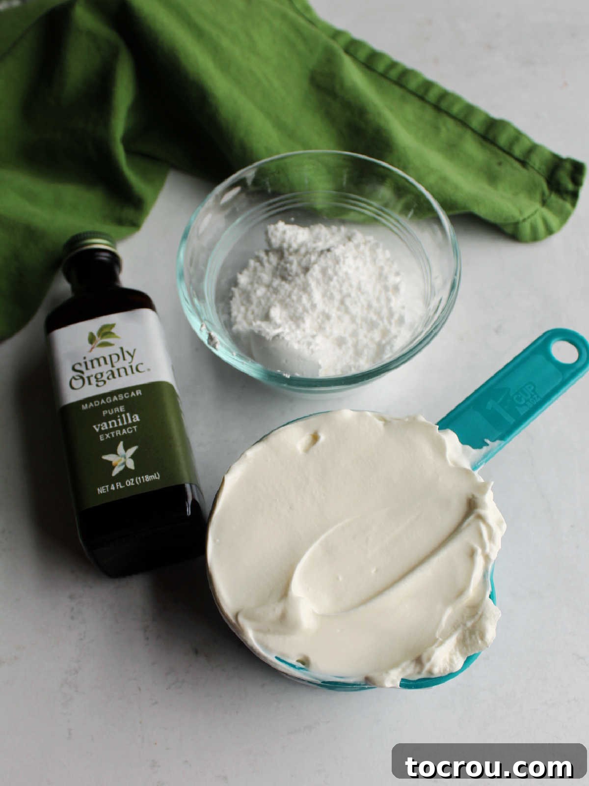 Decadent Pumpkin Cheesecake 7 Sour cream, powdered sugar and vanilla ready to be made into topping.