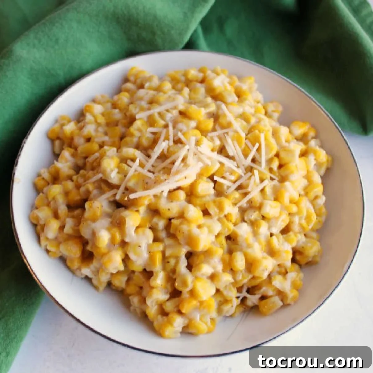 Creamy Parmesan Corn: The Perfect Savory Side Dish for Any Meal A beautifully presented bowl of creamy parmesan corn, garnished with a sprinkle of shredded cheese, ready to be served as a delightful side dish.