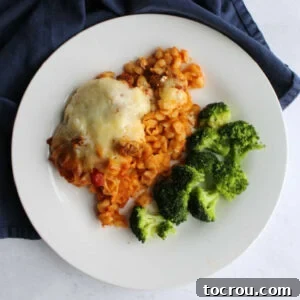 dinner plate with baked Italian style pasta casserole and broccoli.