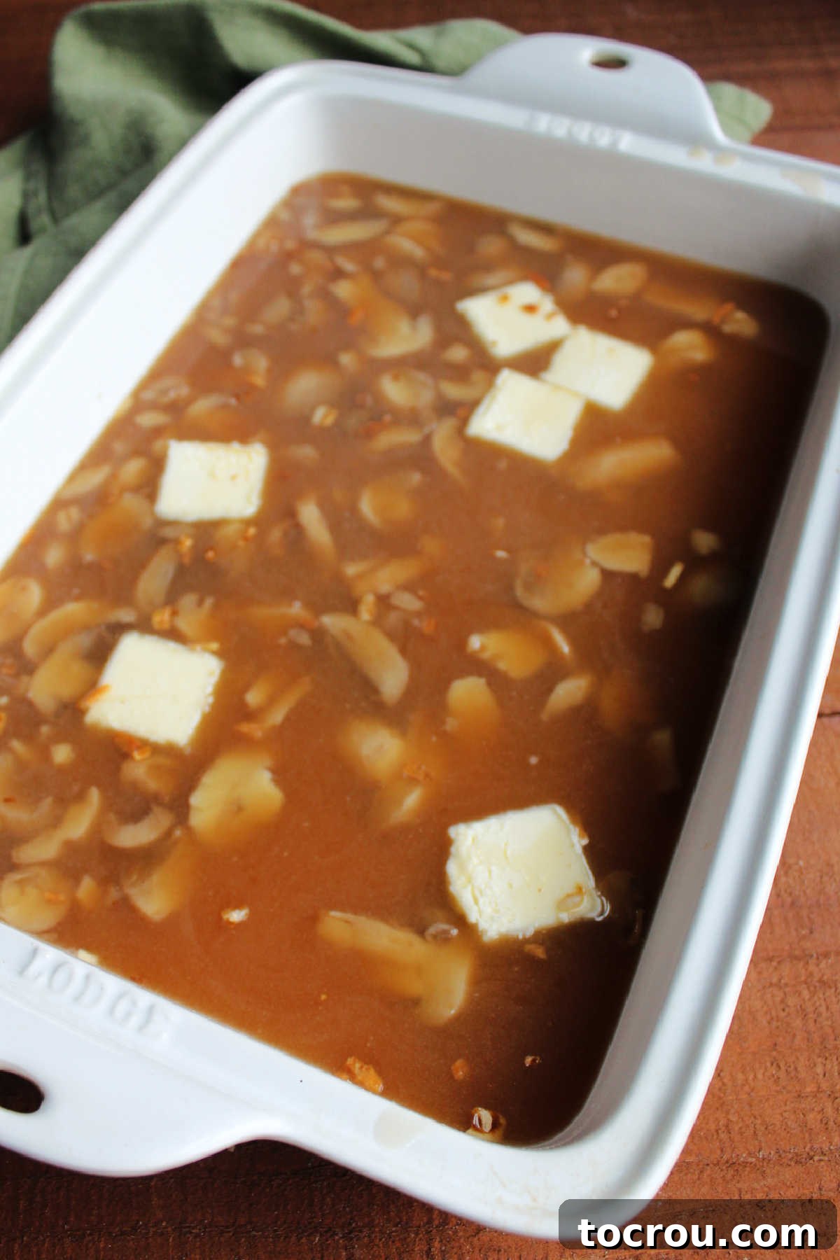 Homestyle Mushroom Rice Bake 4 Baked rice ingredients in casserole dish ready to be covered with foil and baked.