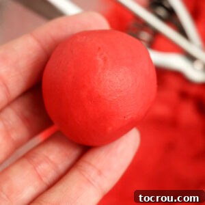 Smooth red truffle after scoop was rolled between hands to smooth it out, showing the perfect round shape.