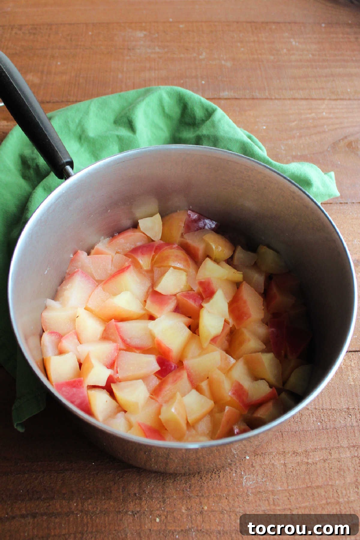 Softened, cooked apples in a saucepan, ready for blending into applesauce.