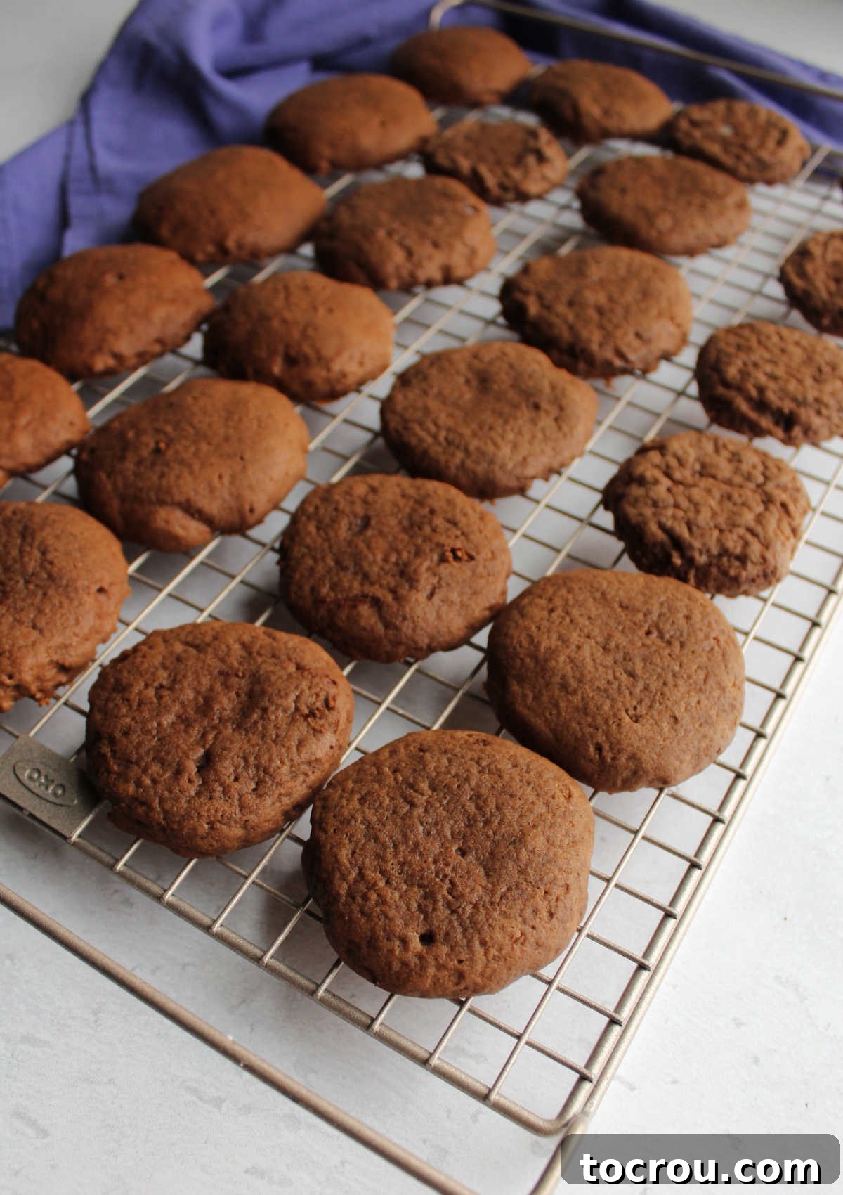 Velvet Chocolate Sour Cream Treats 3 Soft round chocolate sour cream cookies cooling on wire rack.