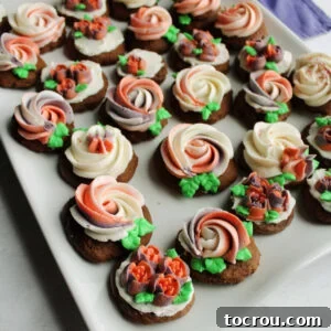 Velvet Chocolate Sour Cream Treats 7 Platter of round chocolate sour cream cookies topped with buttercream rosettes and flowers.