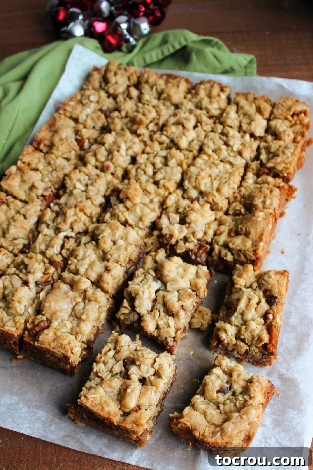 Cooled caramelita bars being carefully sliced into neat squares on a cutting board, ready for serving.