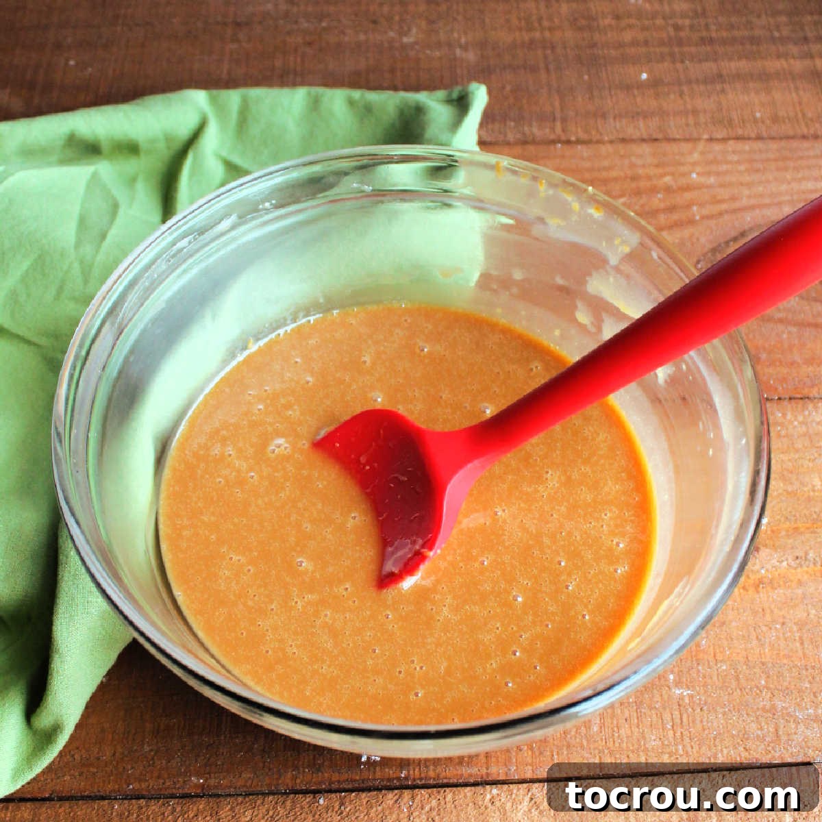 A bowl containing a smooth, melted mixture of caramel and evaporated milk, ready to be used as the gooey filling for the caramelitas.