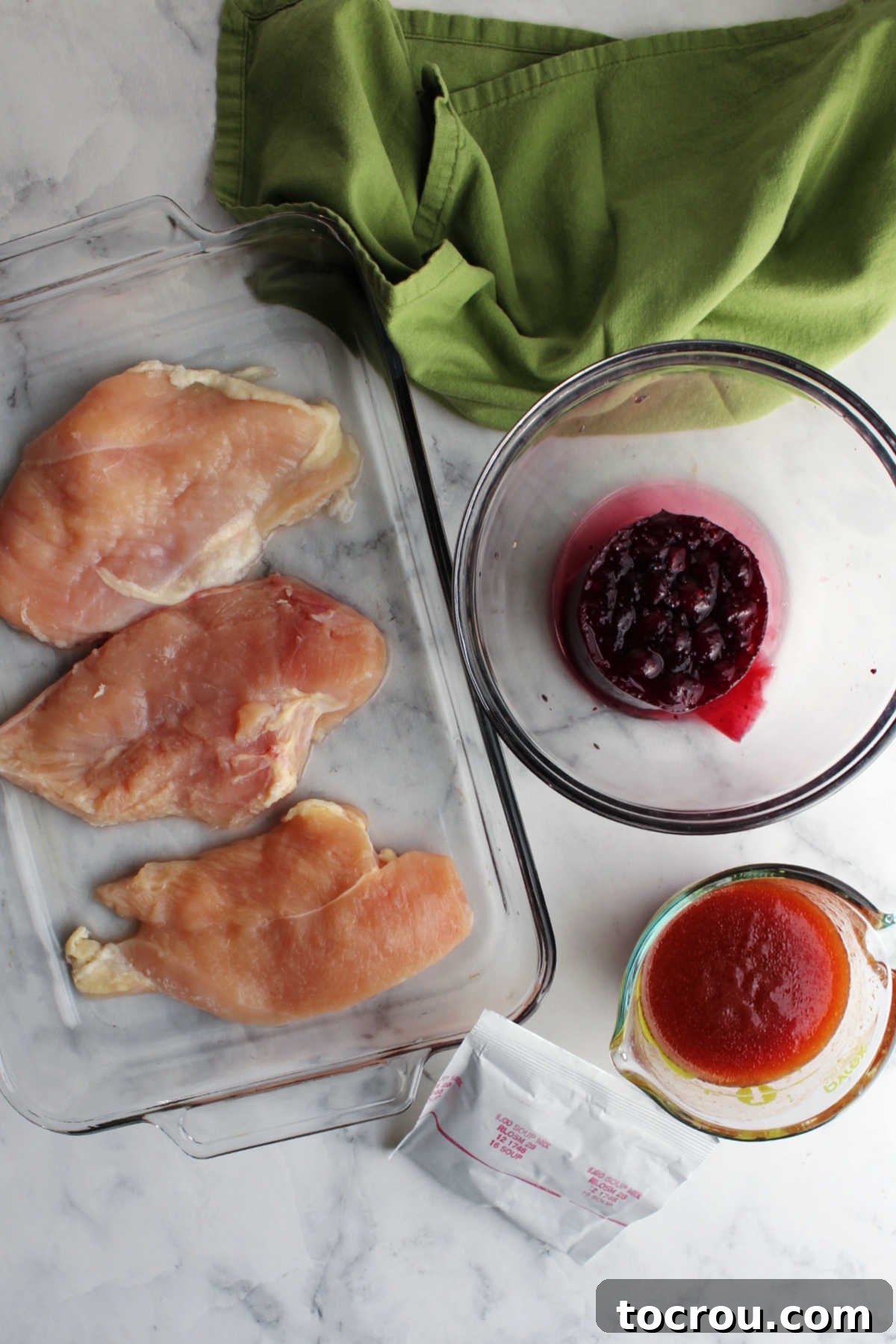 Ingredients: chicken, catalina dressing, onion soup mix packet and whole cranberry sauce ready to be made into chicken.