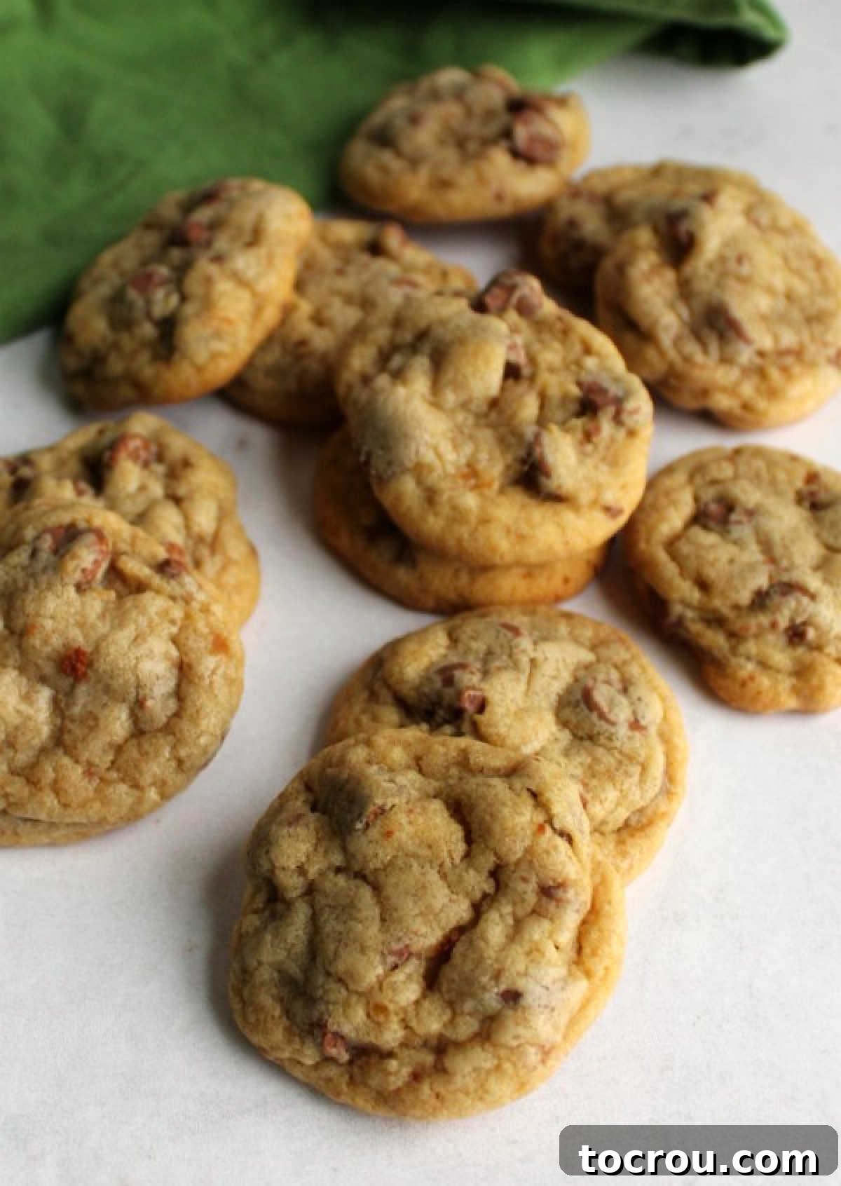 piles of chewy chocolate chip cookies made with vanilla pudding, ready to eat.