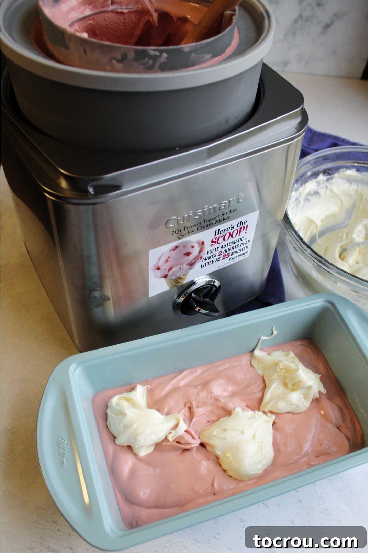 Pink Velvet Cheesecake Swirl Ice Cream 4 Pink velvet ice cream in loaf pan with dollops of cream cheese frosting ready to be swirled in.