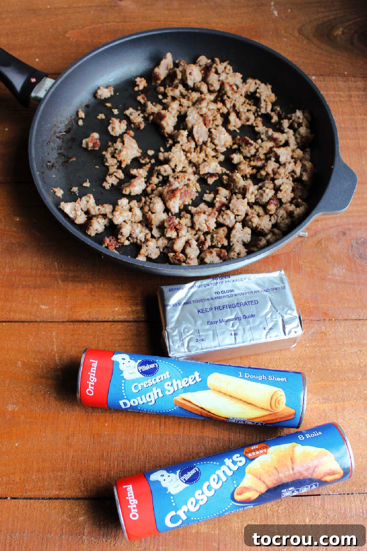 Savory Sausage Cream Cheese Puffs 4 Browned sausage, cream cheese and crescent dough ready to be made into bars.