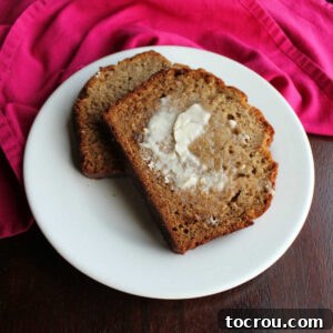slices of banana bread with butter spread on them ready to eat.