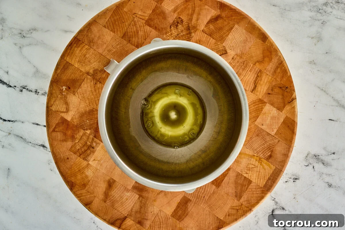 Pure egg whites in a clean mixer bowl, perfectly clear and ready to be transformed into a delicate meringue.