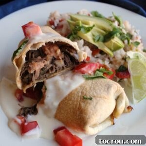 Crispy Baked Barbacoa Chimichangas 8 Crisp tortilla shell filled with refried beans, barbacoa meat, and melted cheese, ready for toppings.