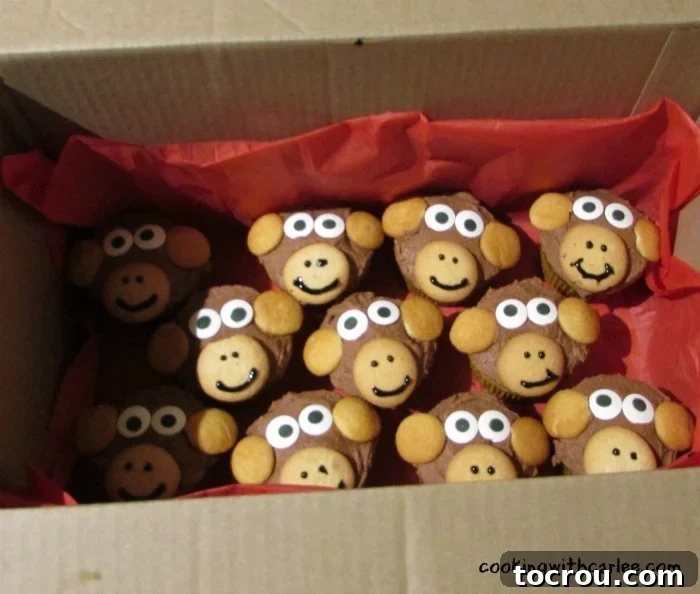 Freshly made monkey cupcakes neatly packed in a box, ready for transport to a party or gathering.