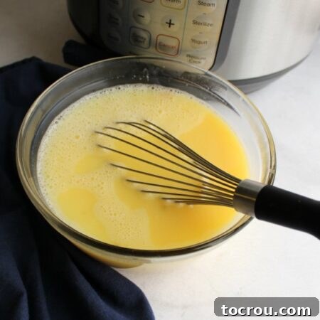 The perfectly tempered lemon and egg mixture, enriched with warm broth, is ready to be gently folded into the main soup pot.