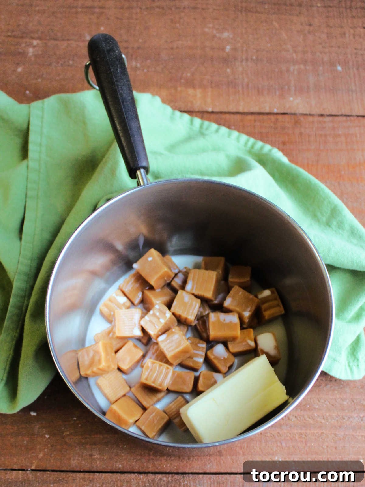 Golden Caramel Pecan Delight 4 Caramels, milk and butter in saucepan ready to be melted.
