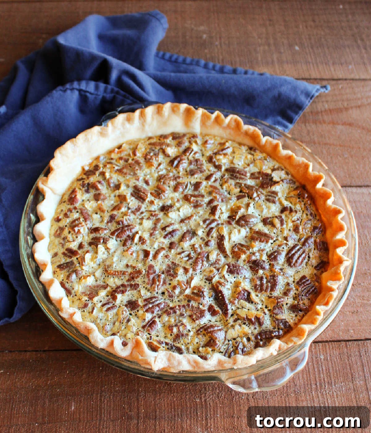 Freshly baked sweetened condensed milk pecan pie with golden brown crust and set filling.