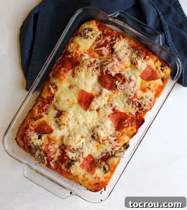 A freshly baked pan of pepperoni bubble up pizza, bubbling and golden, ready to be served directly from the oven.