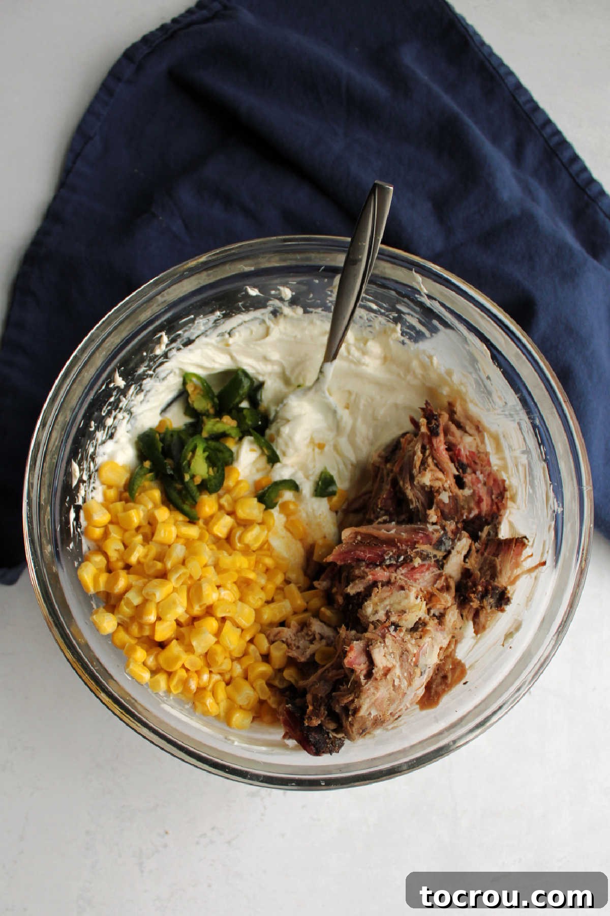 Ultimate Creamy Pulled Pork Dip 2 A large mixing bowl filled with all the creamy pulled pork dip ingredients, prior to baking, showing the rich texture.