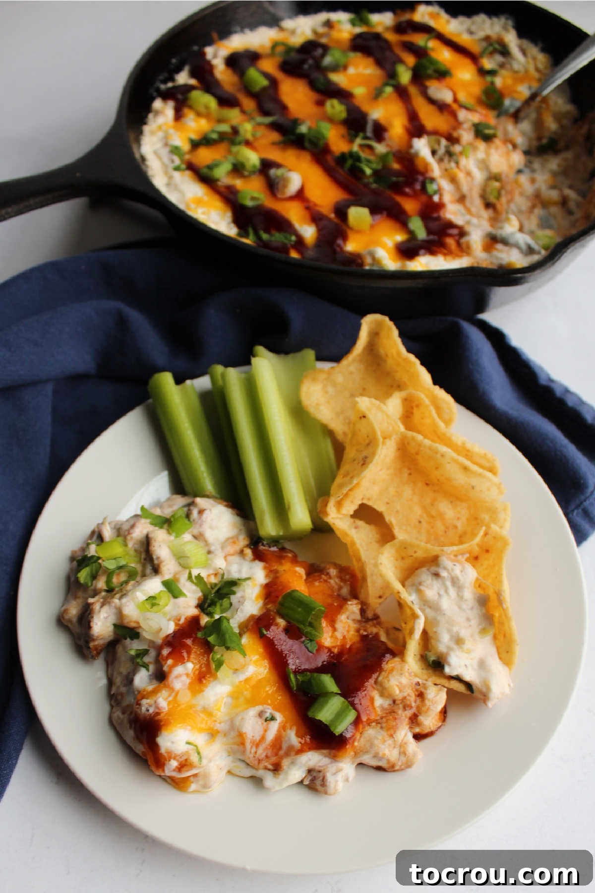 Warm cheesy dip filled with pulled pork and corn is hearty and delicious. It's a great snack for a bbq or game day. A large mixing bowl filled with all the creamy pulled pork dip ingredients, showing the rich texture before being transferred to a baking dish.