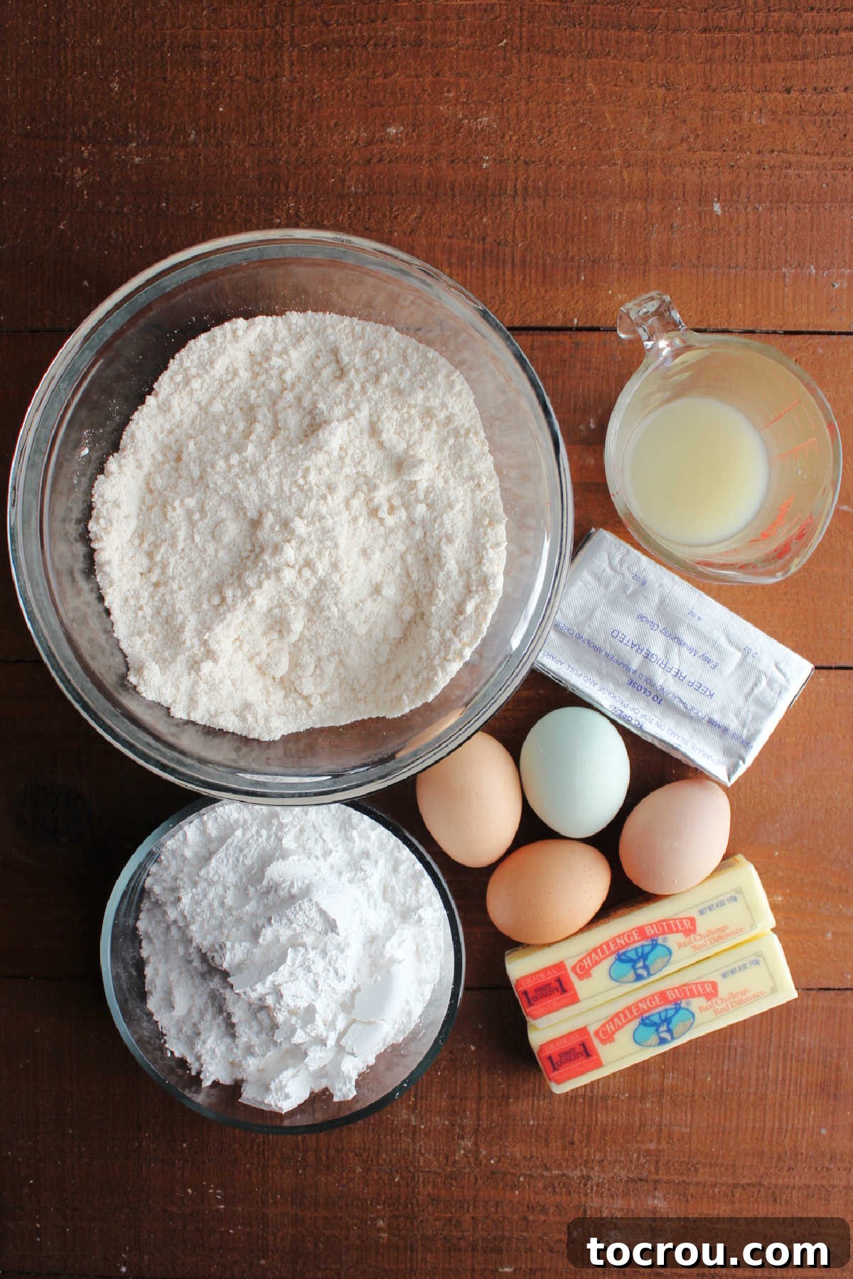 Zesty Lemon Chess Bars 4 Ingredients for lemon chess bars including cake mix, butter, eggs, cream cheese, lemon juice, and powdered sugar.