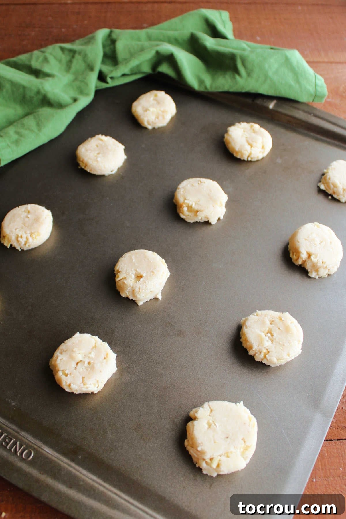Grandmas Golden Crunch Cookies 7 Slightly flattened balls of potato chip cookie dough on baking sheet ready to go in the oven.