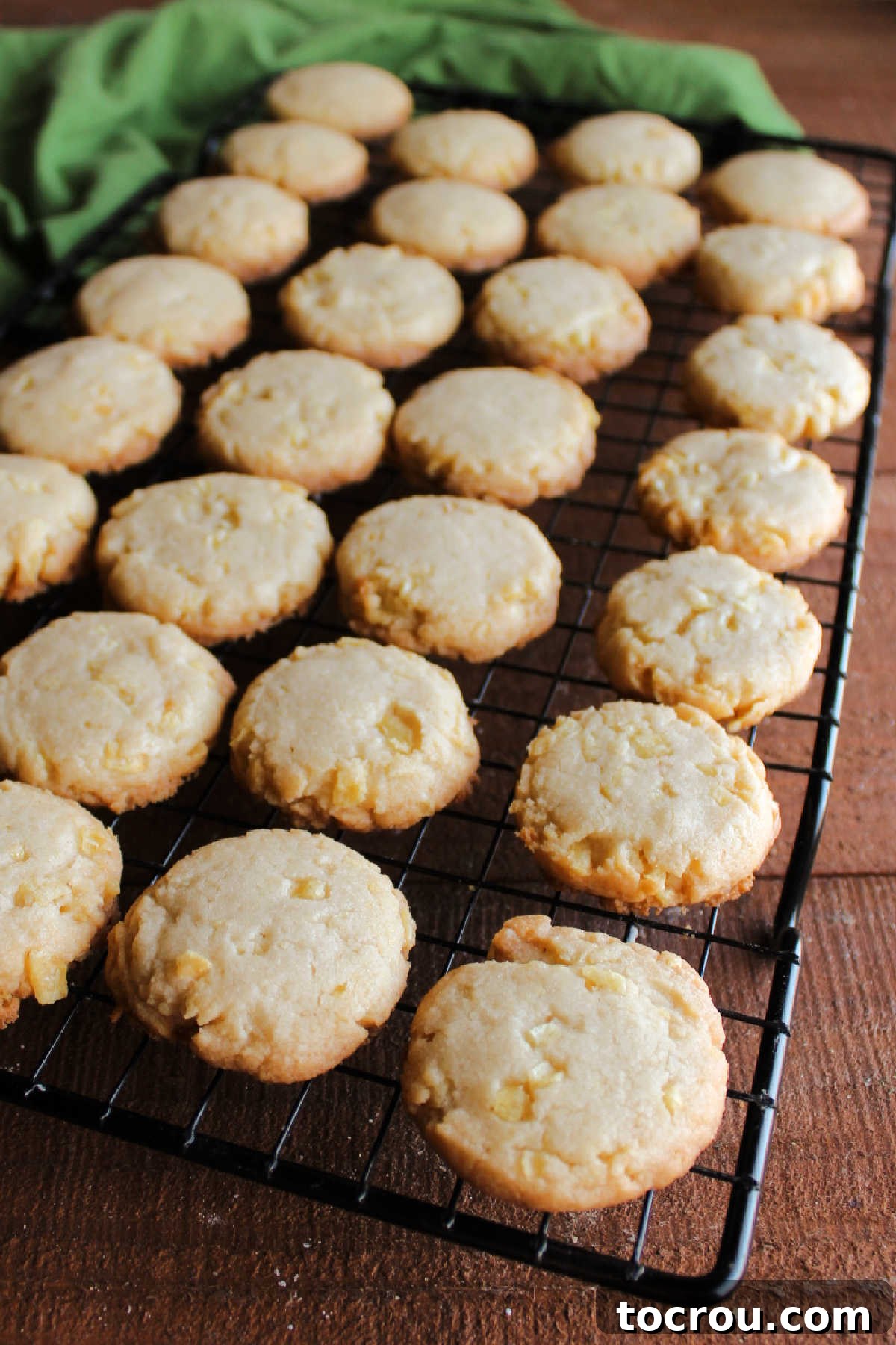 Grandmas Golden Crunch Cookies 8 Potato chip cookies with golden brown edges cooling on wire rack.