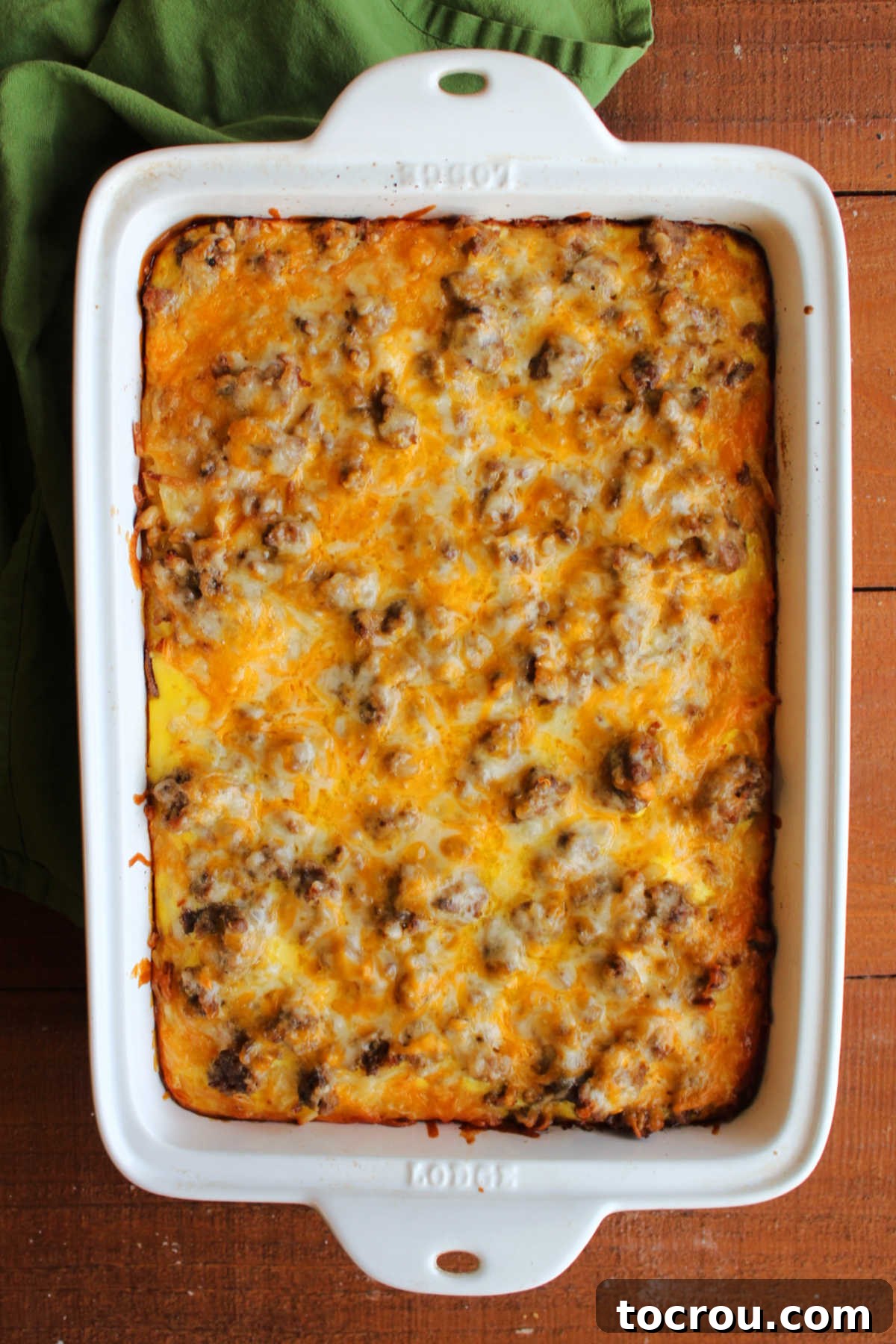 Baked Casserole Fresh from Oven A freshly baked, golden-brown sausage, egg, and hashbrown casserole, hot and bubbling directly from the oven, showcasing a perfectly set texture and melted cheese.
