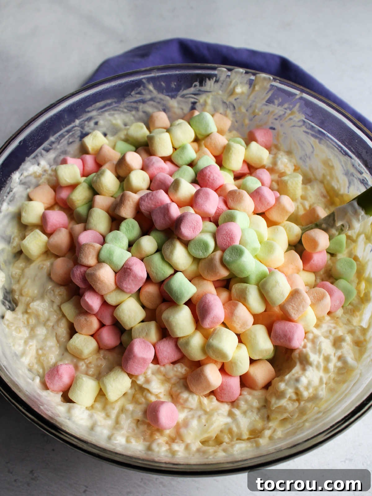 Pastel colored fruity mini marshmallows ready to be stirred into pasta and custard mixture.