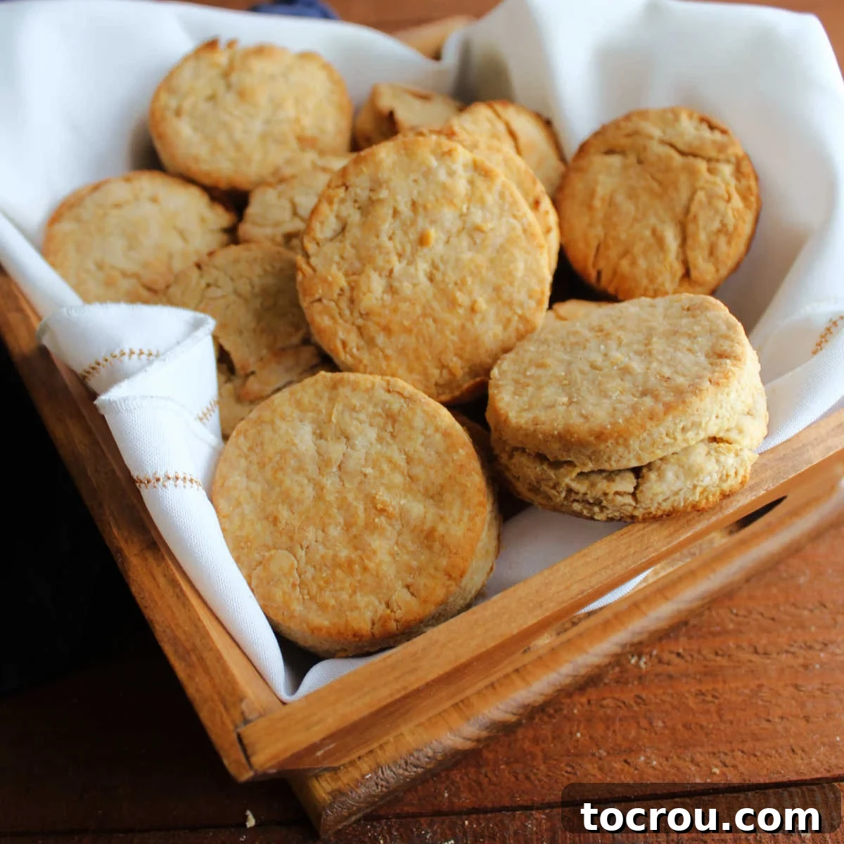 Hearty Homestead Biscuits 2 Basket of golden brown biscuits with crease in the middle, ready to eat.