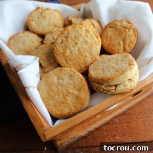Golden Brown Lard Biscuits Basket of golden brown biscuits with crease in the middle, ready to eat.