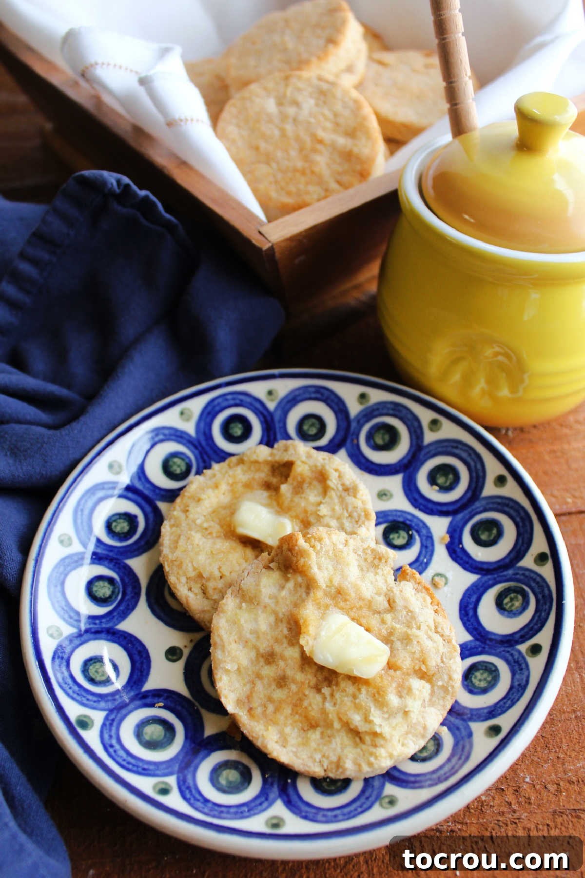 Tender Lard Biscuit Halved with Honey Biscuit cut in half, showing tender insides, topped with butter and honey.