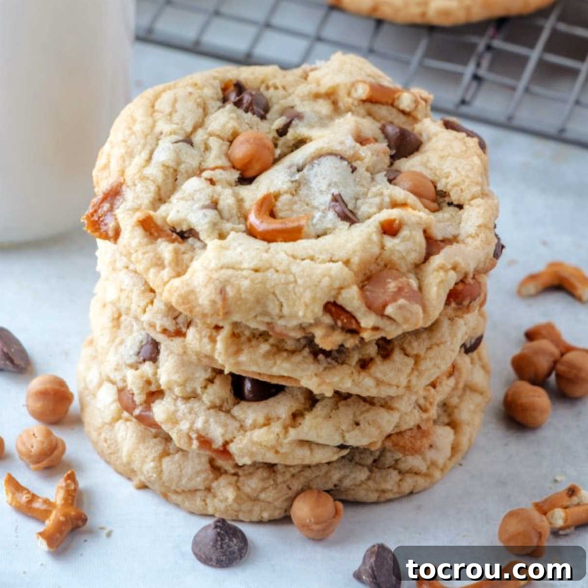 Close up stack of copycat Panera kitchen sink cookies with pretzels, chocolate chips, and caramel.